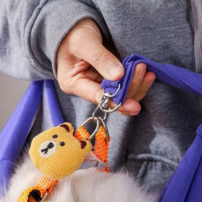Person holding a purple cat carrier sling bag with a secure clip, perfect for traveling with pets.