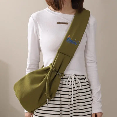 Cat carrier sling bag worn crossbody, ideal for outdoor travel with small dogs or pets, stylish and portable design.