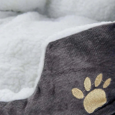 Dog and cat bed with raised sides and thick cushion for security and comfort.