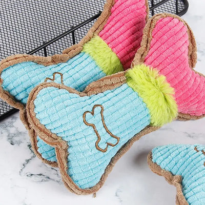 Squeaky dog toy shaped like a bone, made from strong, non-toxic materials for rough play.